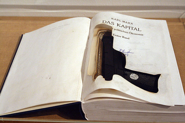 Halil Altındere, Das Kapital. 2009. Laser cut book, gun, 21,5 x 15 x 4,3 cm, 3 C-Prints, mounted on Alu-Dibond,each 50 x 35 cm (Detail).